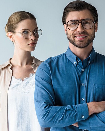 Man & woman wearing designer eyeglasses