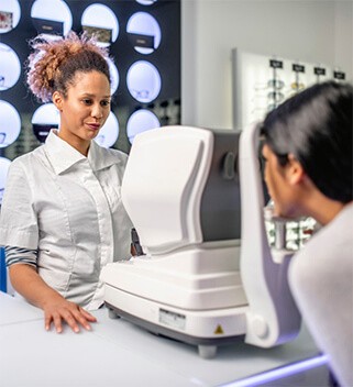 Patient getting eye exam from vogue vision eye doctor