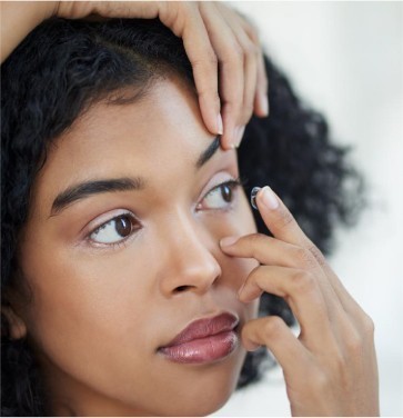 Woman putting in contact lenses