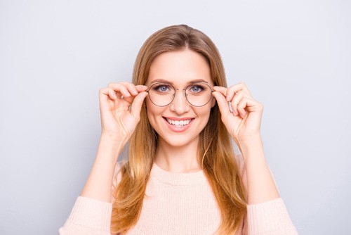 Woman holding eyeglasses