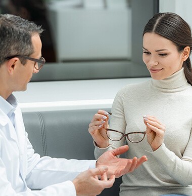 Woman talking with optometrist about glasses